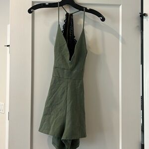 Green open back romper with black lace